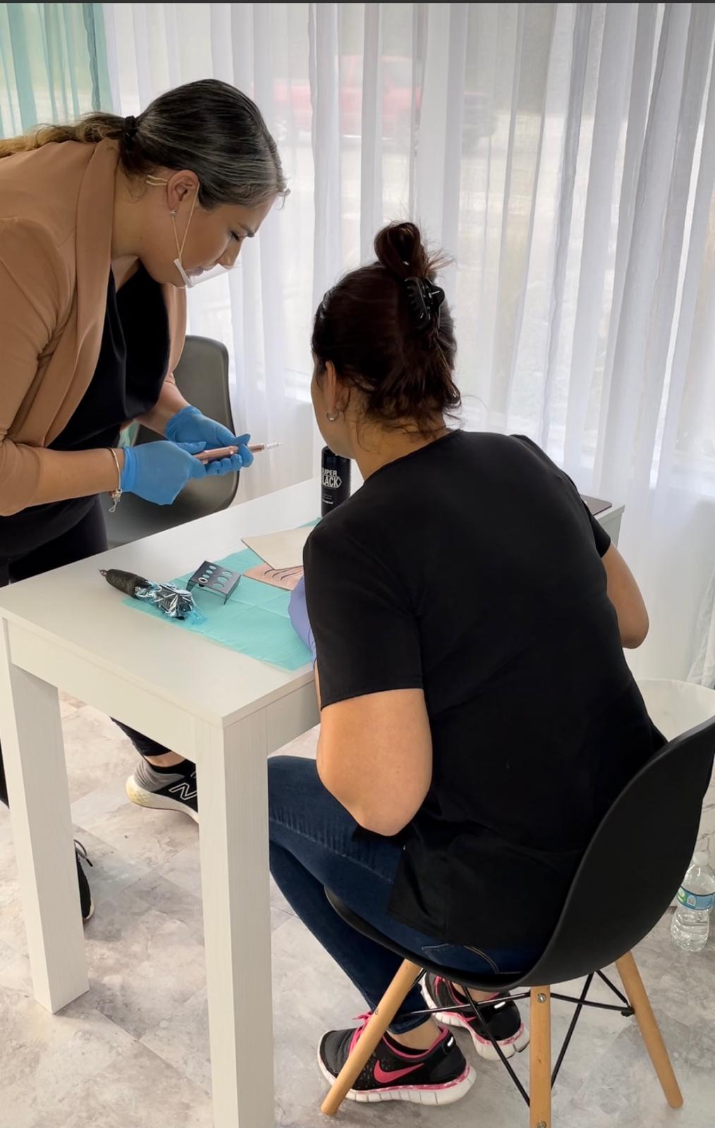 Linda demonstrating machine technique to a student